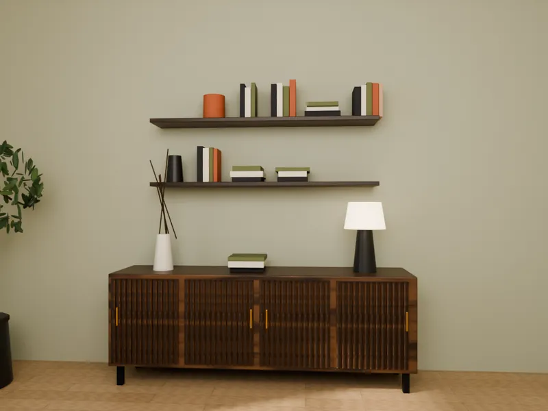 A fluted walnut sideboard with wall shelves, books, vases and a table lamp