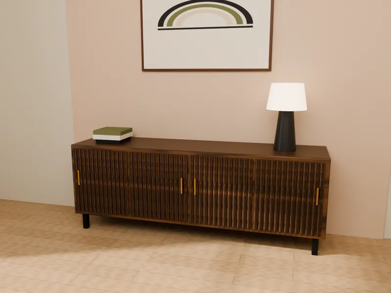 A fluted walnut credenza with a lamp, books and wall art
